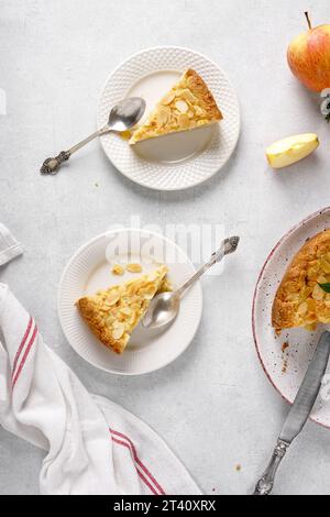 two plates with pieces of apple pie on the kitchen table Stock Photo