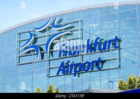Close-up view of the large sign and logo of the Frankfurt airport displayed on the glass facade of the Terminal 2 building on a sunny summer day. Stock Photo