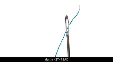 Steel needle with blue threat isolated on white background with copy space closeup. Fabric tool for craft textile sew macro view Stock Photo