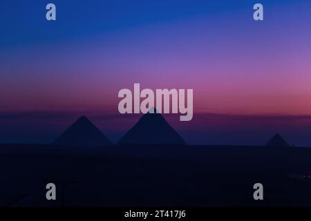 The Great Pyramids of Egypt at night. A desert landscape, the only surviving wonder of the world. Stock Photo
