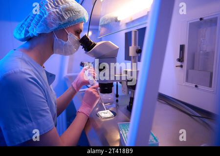 Focused researcher preparing biological samples for microscopic examination Stock Photo