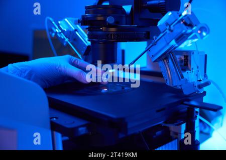 LAb researcher preparing for cell manipulation with micromanipulator in lab Stock Photo