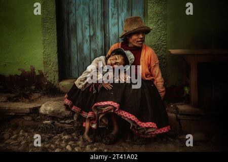 A little girl gets angry with her mother, in a village in Cusco, Peru. Stock Photo
