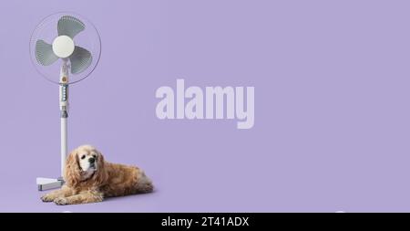 Cute dog and electric fan on lilac background with space for text Stock Photo