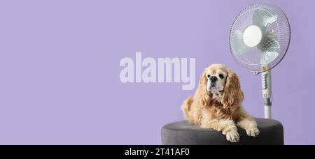 Cute dog and electric fan on lilac background with space for text Stock Photo