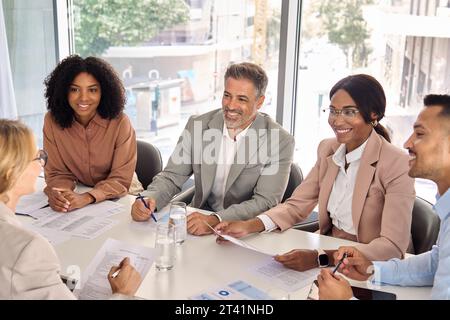 Happy diverse executive business people working together at meeting in office. Stock Photo