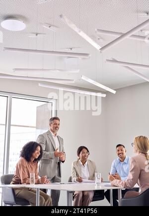 Happy senior business man ceo working with diverse team at office meeting. Stock Photo