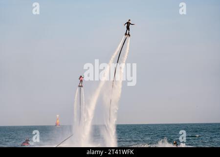 Busan, Korea -May 25, 2023: Two guys is playing the aquatic flyboard at Haeundae, Busan, South Korea Stock Photo