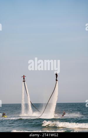 Busan, Korea -May 25, 2023: Two guys is playing the aquatic flyboard at Haeundae, Busan, South Korea Stock Photo