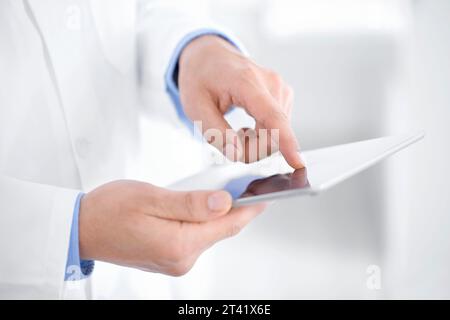 Doctor using tablet computer Stock Photo