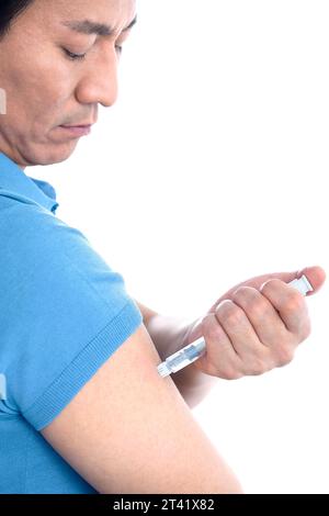 Man self-injecting Stock Photo