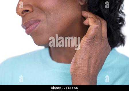 Woman scratching her neck Stock Photo