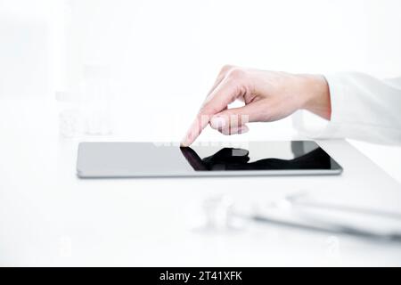 Doctor using digital tablet Stock Photo