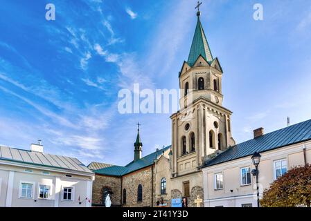 View of the Church of the Exaltation of the Holy Cross on the main square of the city - Rynok Square, Sanok, Poland. Stock Photo