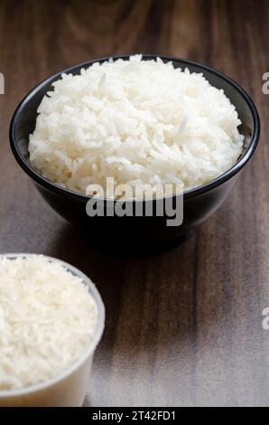Rice in cup on wooden table blurred background Stock Photo