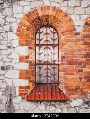 Metal security bars installed on a window with visible pipes and ...