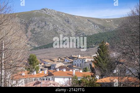 View of the village of Candelario with its houses, roofs and blue sky and in the background the Sierra de Bejar. Salamanca, Spain. Stock Photo