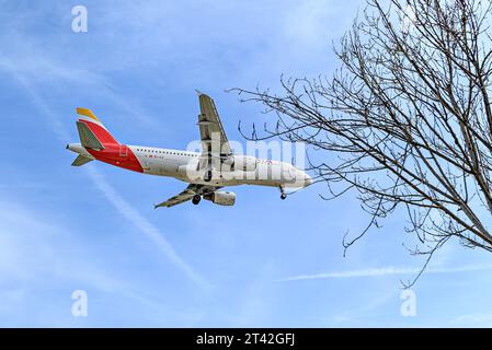 Barcelona, Spain; April 10, 2023: Airbus A320 plane of the Iberia company, landing at the Josep Tarradellas Barcelona-El Prat airport Stock Photo