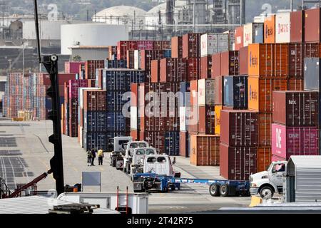 Beijing, China. 28th Oct, 2023. Trucks wait to load containers at the port of Los Angeles, California, the United States, Oct. 22, 2021. Credit: Xinhua/Alamy Live News Stock Photo