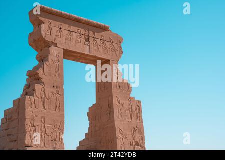 Carvings of gods and hieroglyphs on the sandstone entrance to Dendera Stock Photo