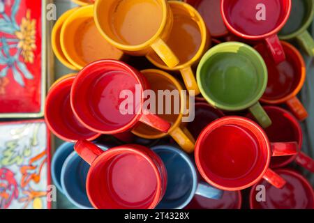 Overhead close-up of assorted multi coloured cups for sale in a market, New Delhi, India Stock Photo