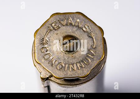 An Evans Patent Concinnum Machine, a vintage cigarette rolling device.  End view showing the knob which turns the brass rollers. Stock Photo