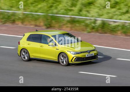 2022 Volkswagen Golf R-Line Etsi S-A 1.5 Etsi EVO 150 MHEV DSG Auto Start/Stop Yellow Car Hatchback Hybrid Electric 1498 cc travelling at speed on the M6 motorway in Greater Manchester, UK Stock Photo