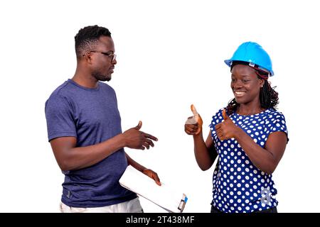 two young construction engineers working on a project together. man holding clipboard. Stock Photo