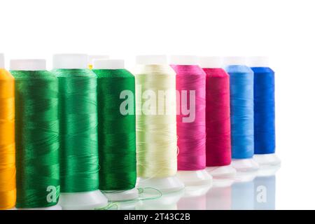 set of different color sewing threads, isolated on white background. Stock Photo