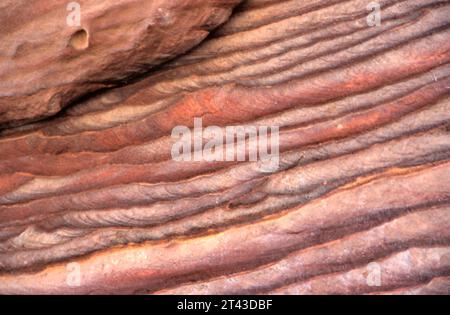 Red brown rock stone sand texture background. Red brown stone wall in Petra, Jordan. Stock Photo