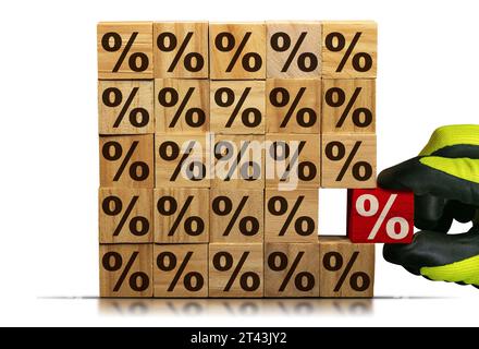 Gloved hand chooses a wooden block with red percentage sign, from a stack of wooden blocks with brown percent signs. Isolated on white background. Stock Photo
