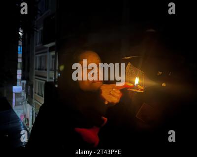 October 28, 2023, Kathmandu, Bagmati, Nepal: A woman offers prayers after lightening Aakashdeep (oil lamp) on full moon day during evening on October 28, 2023. The world will experience the last lunar eclipse of the year as a partial lunar eclipse on full moon day on October 28. (Credit Image: © Sunil Sharma/ZUMA Press Wire) EDITORIAL USAGE ONLY! Not for Commercial USAGE! Stock Photo