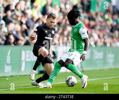 Celtic's Alistair Johnston (left) and Hibernian's Elie Youan battle for the ball during the cinch Premiership match at Easter Road Stadium, Edinburgh. Picture date: Saturday October 28, 2023. Stock Photo