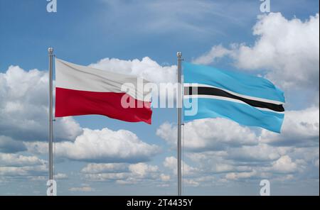 Poland and Botswana flags waving together in the wind on blue cloudy ...