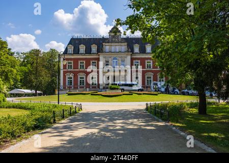 Wroclaw, Poland - June 11 2023: Beautiful and colorful Pawlowice park with a lot of beautiful trees and flowers and big and beautiful palace at center Stock Photo