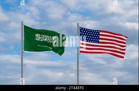 USA and Saudi Arabia flags waving together in the wind on blue cloudy sky, two country relationship concept Stock Photo