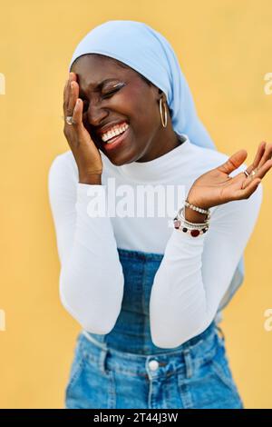African muslim woman with hijab laughing happily Stock Photo