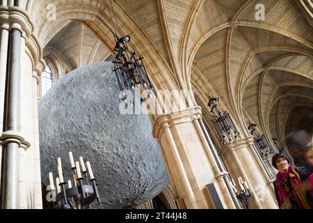 London UK 28th October 2023. Visitors to London Southwark Cathedral were treated with a moon sculpture installation at seven meters in diameter spanning the entire cathedral. it is designed by Luke Jerram's Museum of Moon  at approximate sale of 1:500,000. Credit: Xiu Bao/Alamy Live News Stock Photo