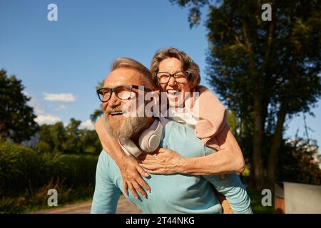 Happy active senior couple having fun outdoor in city park Stock Photo