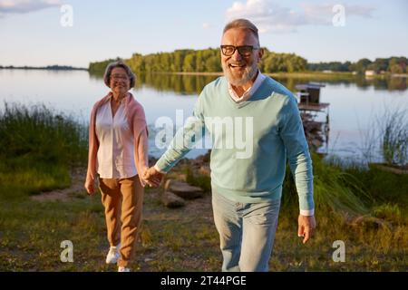 Happy shiny smiling elderly couple spending time on nature Stock Photo