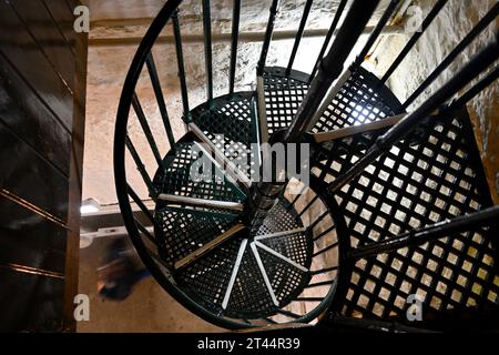 Looking down spiral metal staircase in bell town of historic church tower Stock Photo