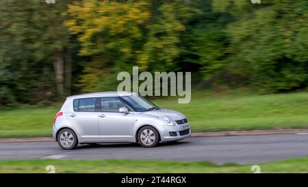 Milton Keynes,UK - Oct 28th 2023: 2009 silver Suzuki Swift car driving on an English road Stock Photo
