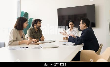 Serious diverse business colleagues discussing work on project Stock Photo