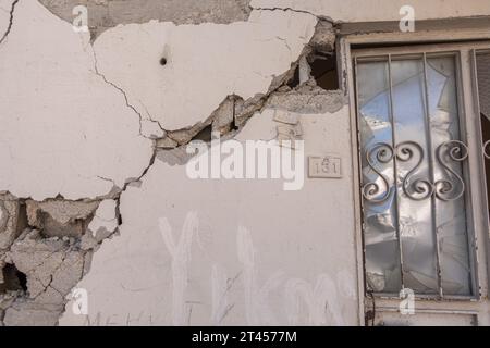 Cracked wall, window, building number building on the damaged by Earthquake 2023 house in Antakya Turkey Stock Photo