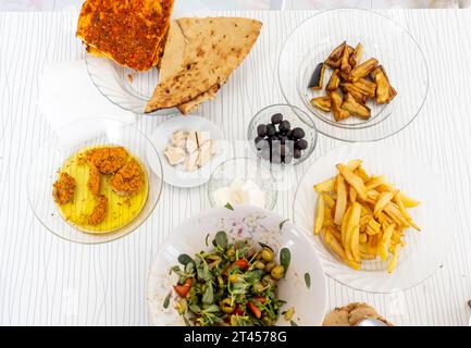 Turkish breakfast served in Hatay province: olives, bread, salad Stock Photo