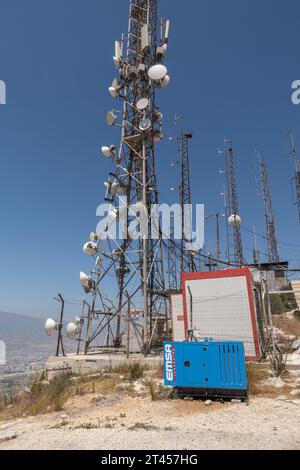 Telecommunication poles, Collocated antennas on towers, mobile connection tower on the hill in Hatay Turkey Stock Photo
