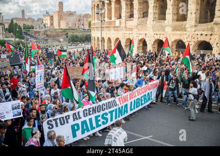 Rome, Italy. 28th Oct, 2023. Palestinian flags and demonstrators behind the banner ''Stop the genocide, end the occupation, Free Palestine!'' during the demonstration in support of the Palestinian people in Rome.The national demonstration organized by Palestinian associations in Italy in support of the struggle of the Palestinian people saw the participation of around 20 thousand people, according to the police headquarters, coming from all over Italy to reiterate the right to self-determination of the Palestinian people and ask the Italian Government to condemn of the 'attempt at ethnic c Stock Photo
