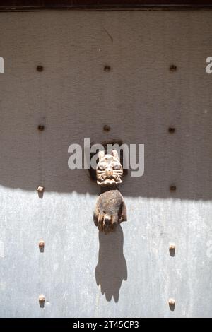 Door handle, Iron Door Knocker, Metal Ring Pull, animal head with a hand. Gaziantep Turkey Stock Photo