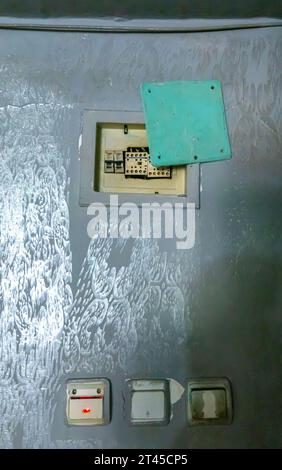 Row of dirty used badly painted plastic light switches on a wall. Concept- electricity Stock Photo