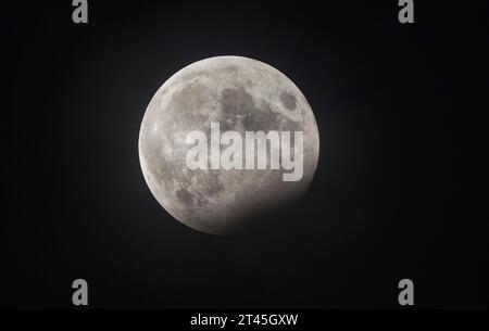 The partial lunar eclipse is visible from Whitley Bay on the north east coast of England. Picture date: Saturday October 28, 2023. Stock Photo